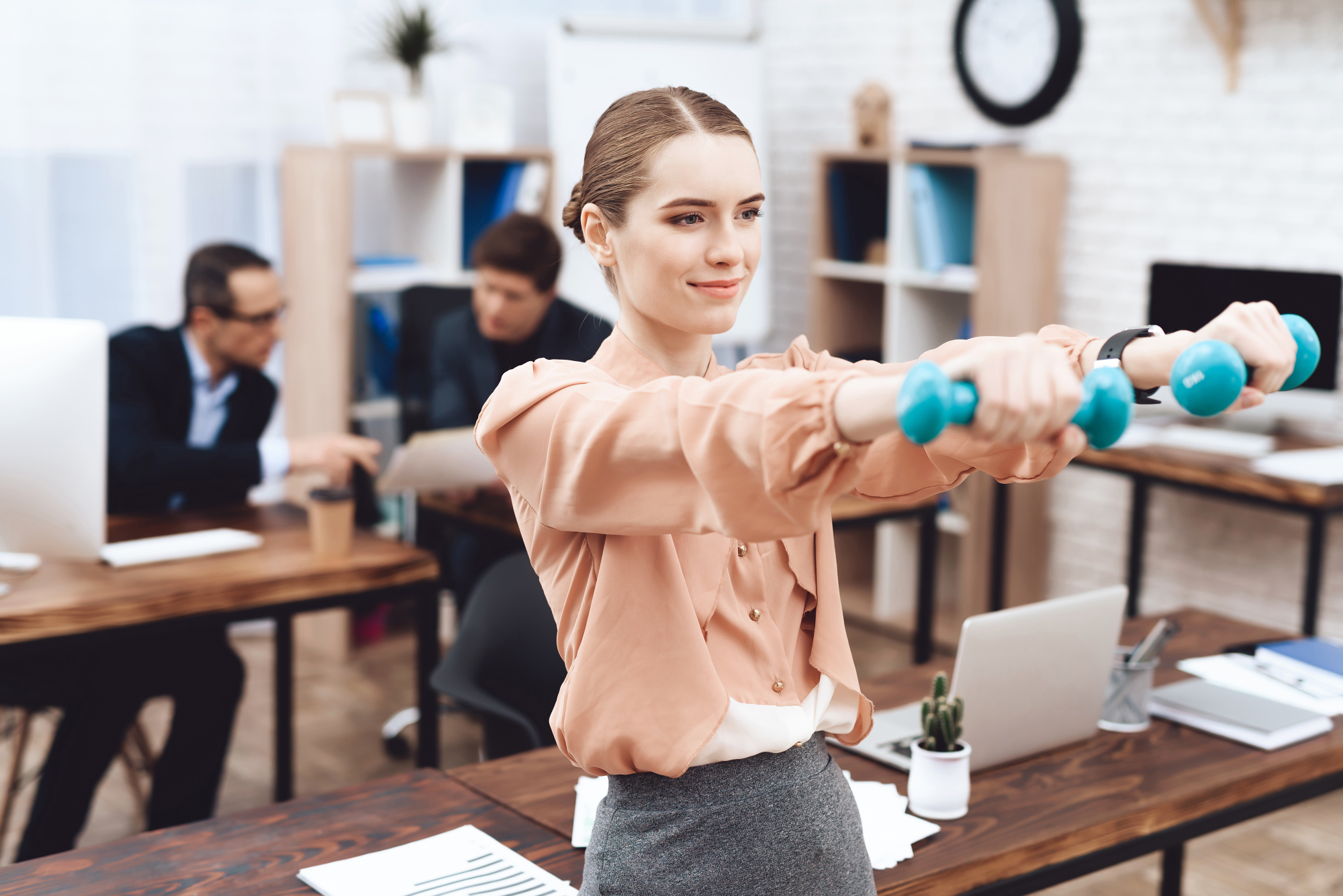 dqs-a young woman does gymnastic exercises at work