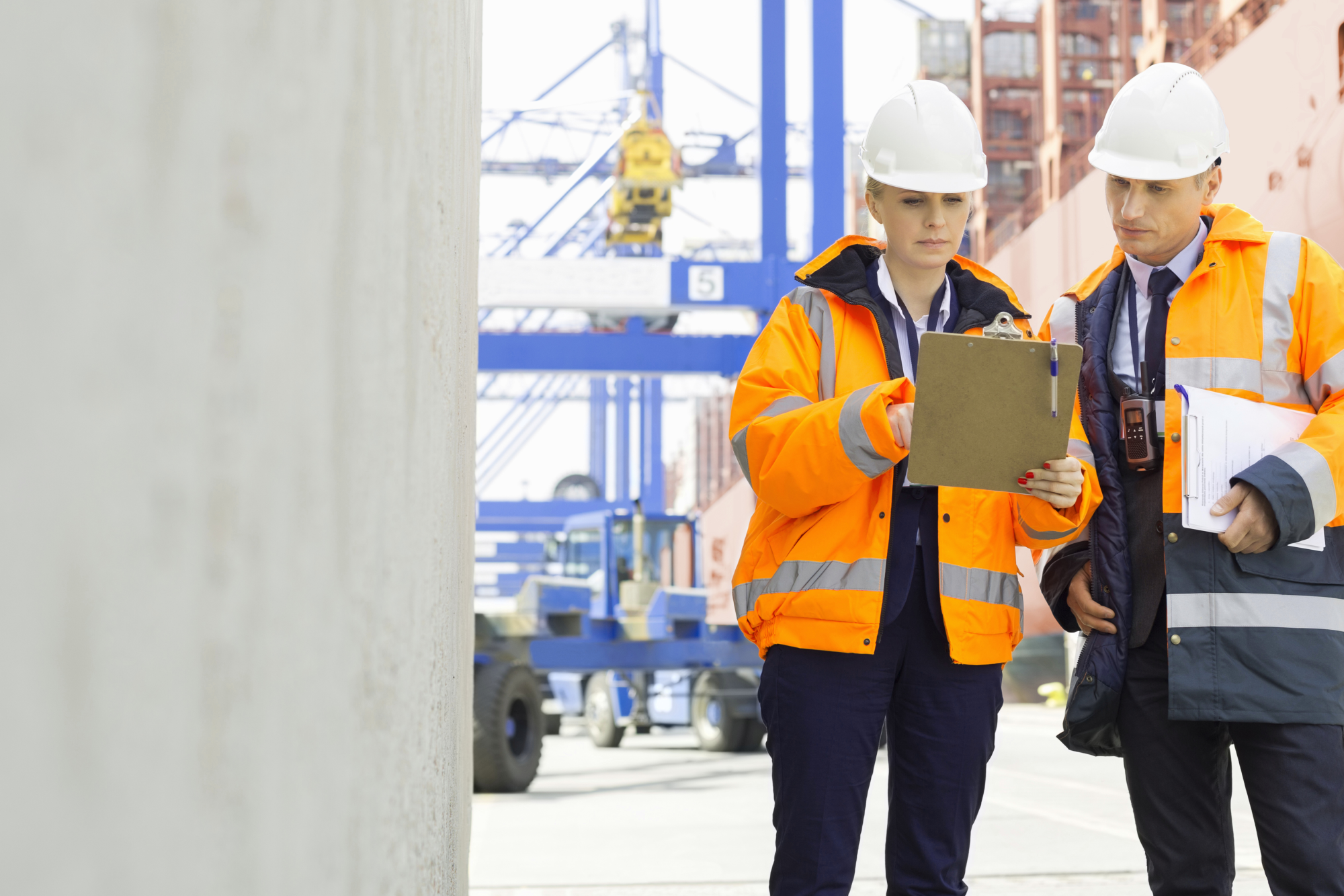 iso-45001-introducing-dqs-two workers complete tasks at ship port