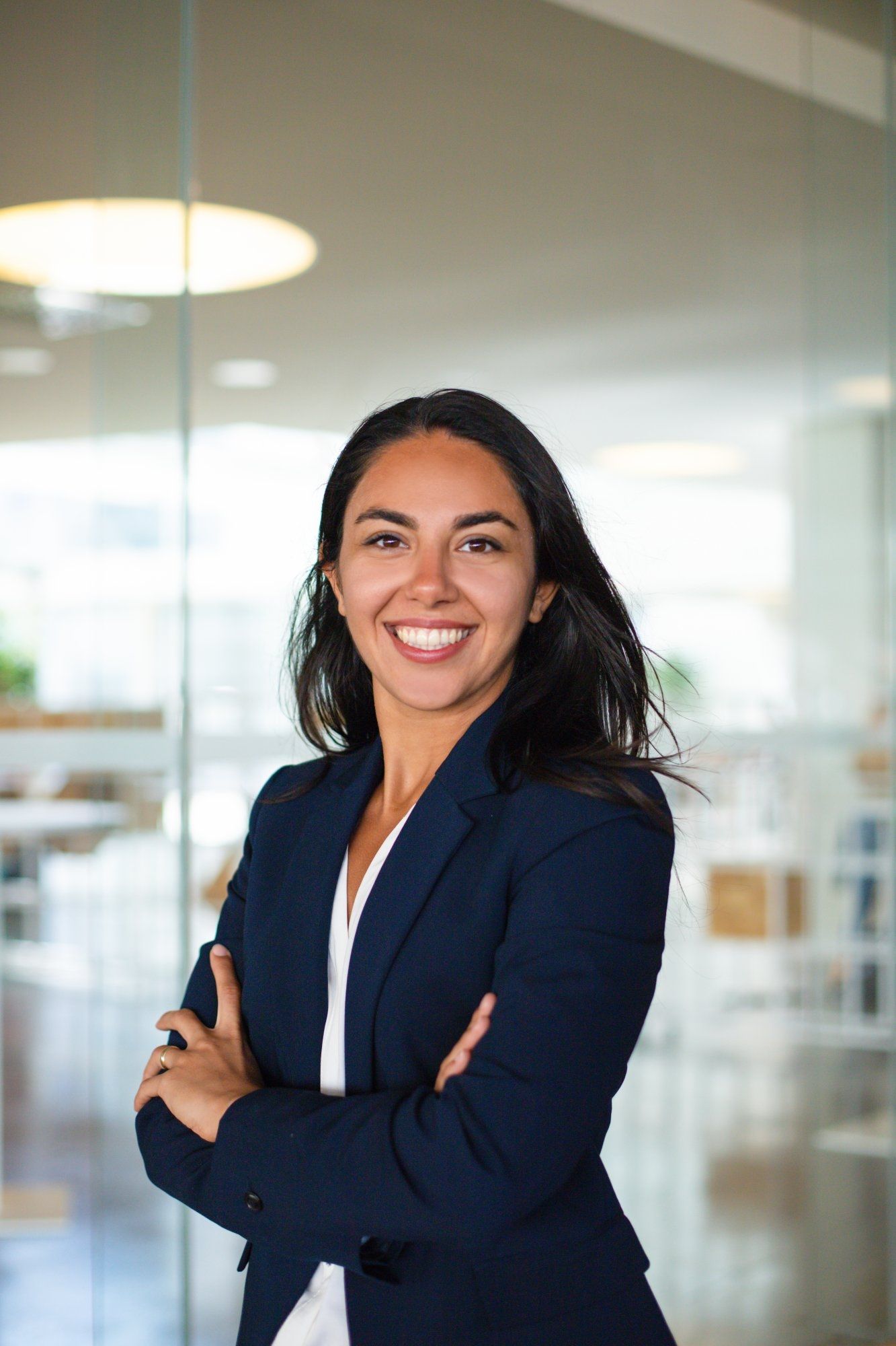 Content businesswoman smiling at camera. Portrait of beautiful happy young businesswoman standing wi