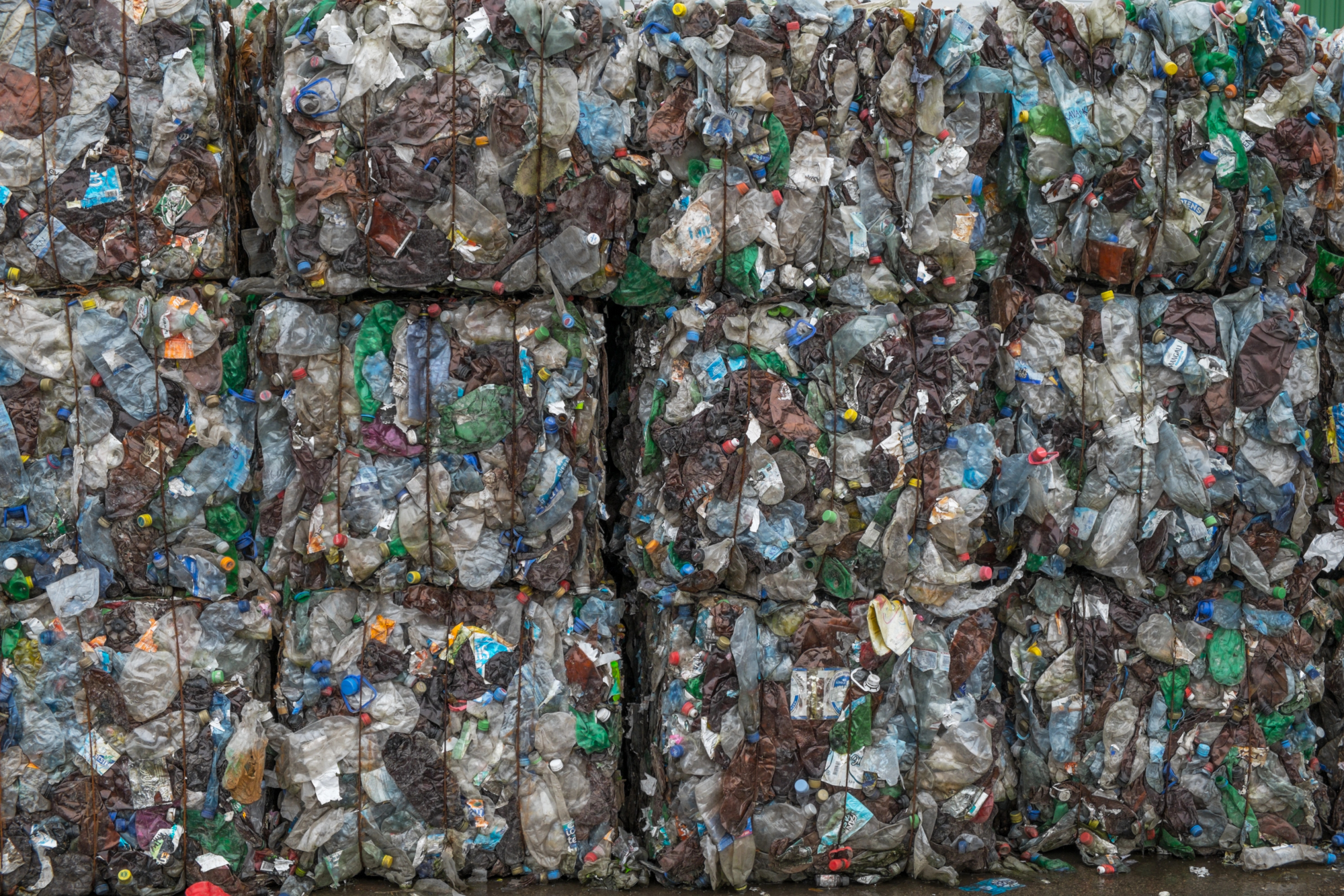 Piles of pressed plastic bottles ready for recycling
