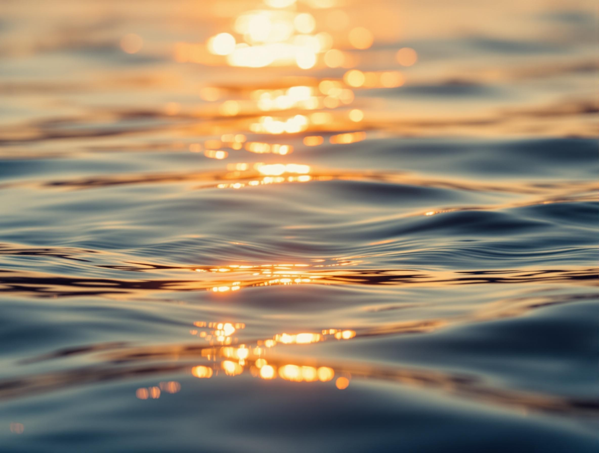 Liquid surface reflekting the sunlight - evening mood, water