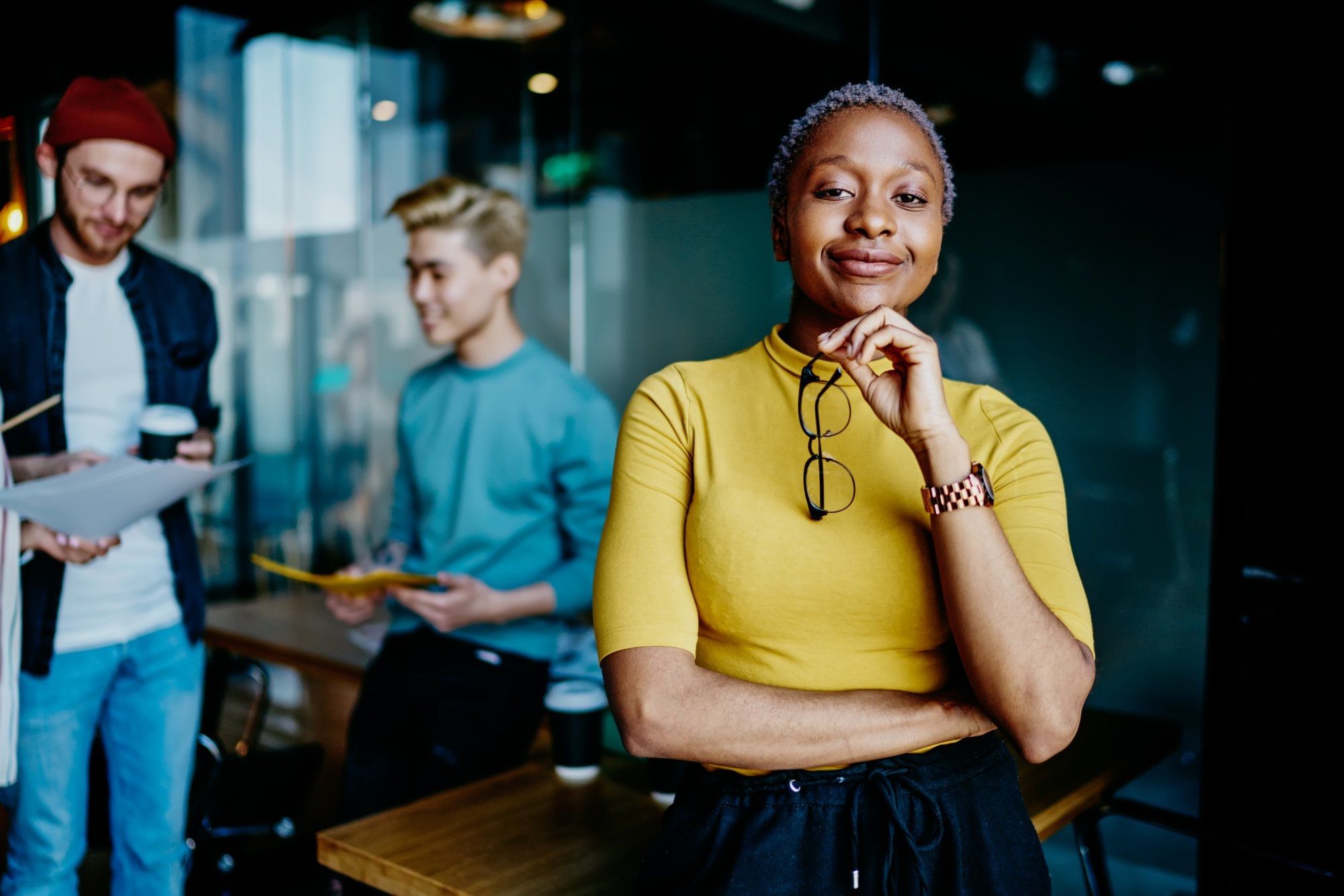 contact-about-dqs-confident businesswoman stands in front of colleagues