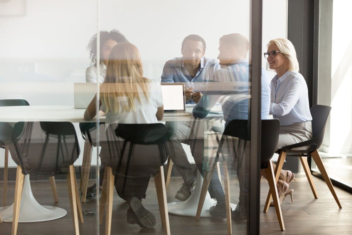 header-about-dqs-a group working together in an office space