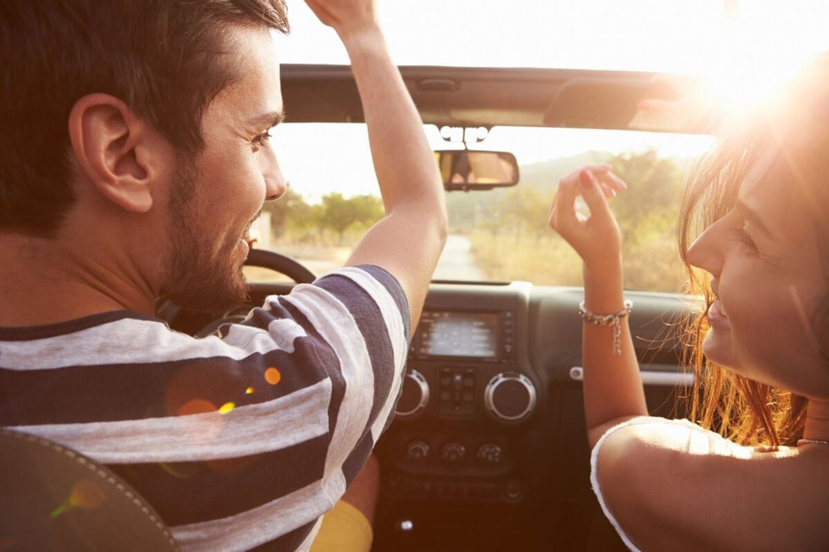 people in a car driving down the road happily