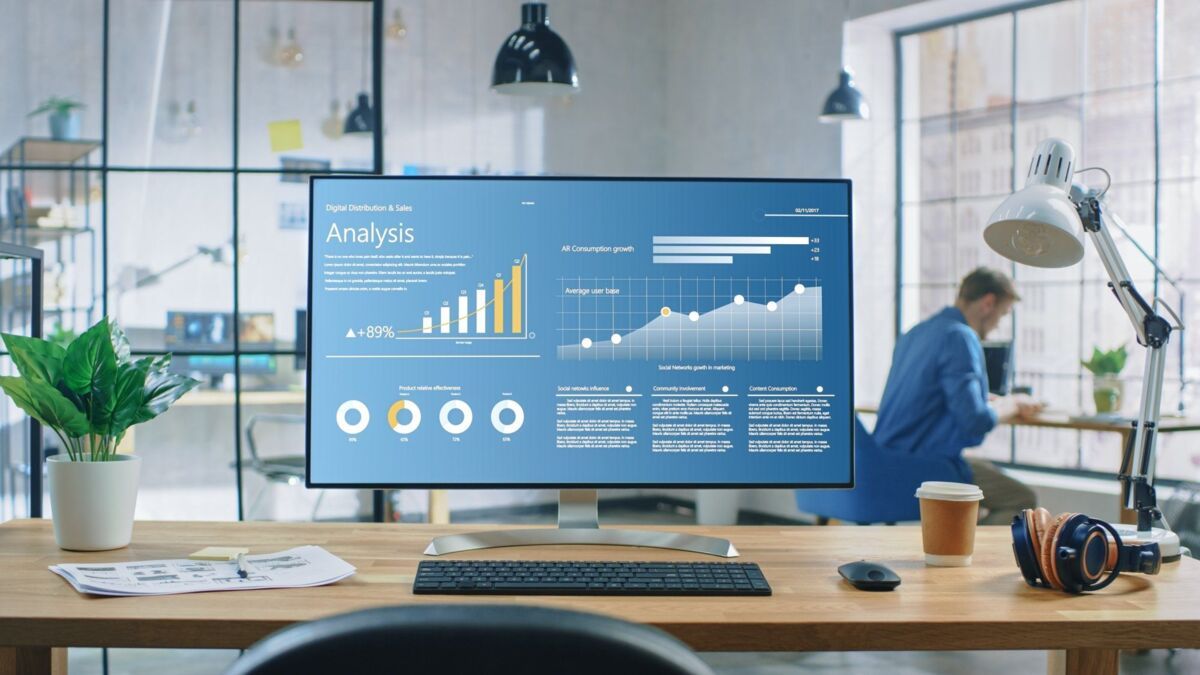 it-security-vs-information-security-dqs-modern office space with large monitor displaying analytics 