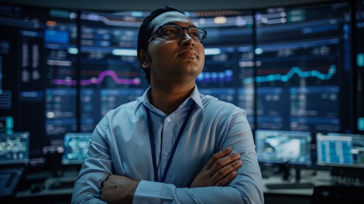 looking-for-certify-dqs-one man standing in front of many screens