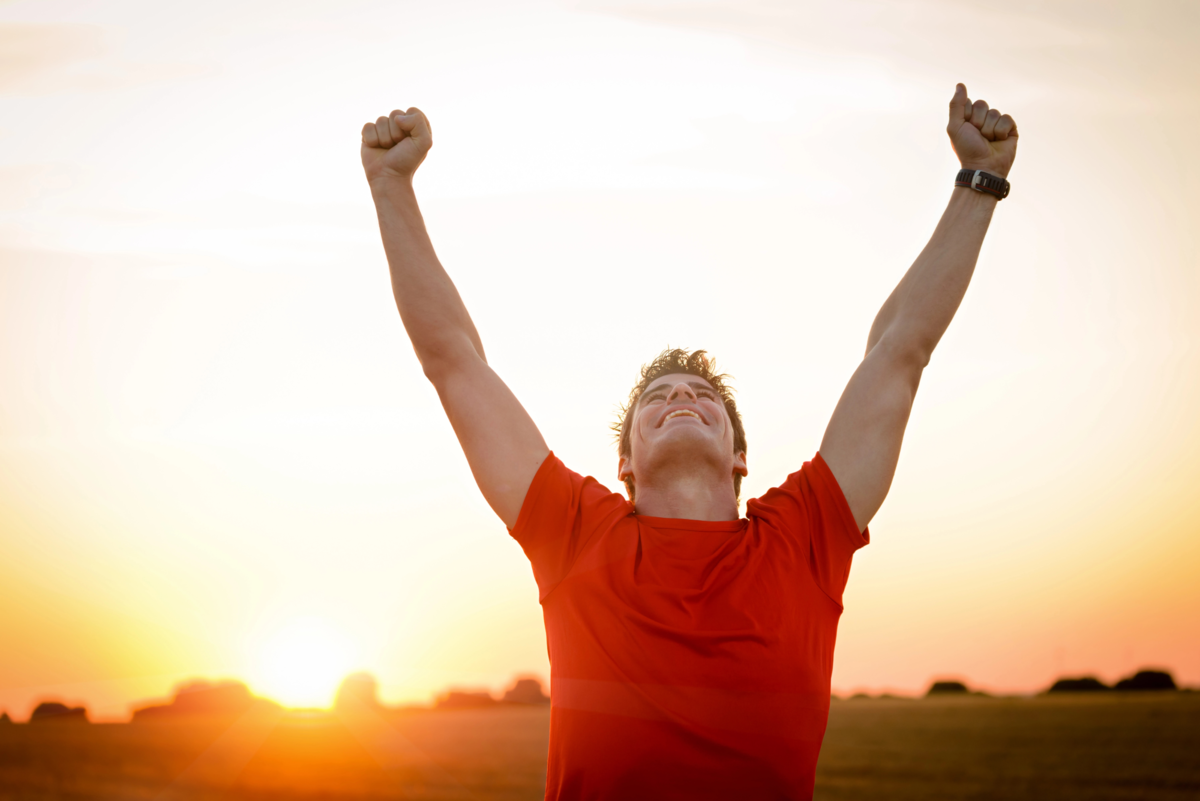 Man raises both arms in a gesture of success