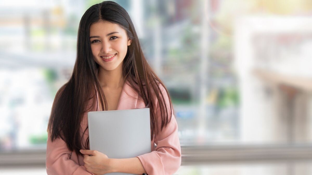 business asian woman hold paper folder file with big smile and feeling confident. with blurred outdo