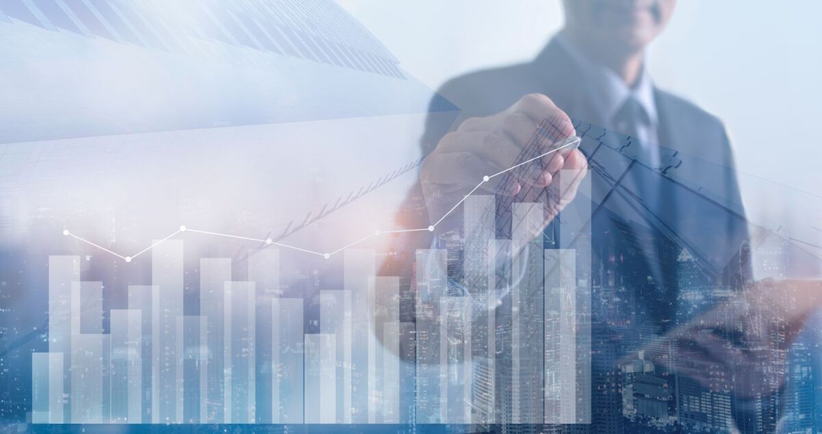 Man digitally drawing success curve of financial development