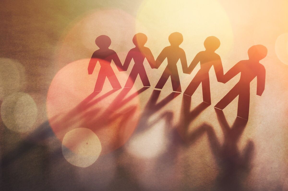 Paper group people in a Circle Holding Hands