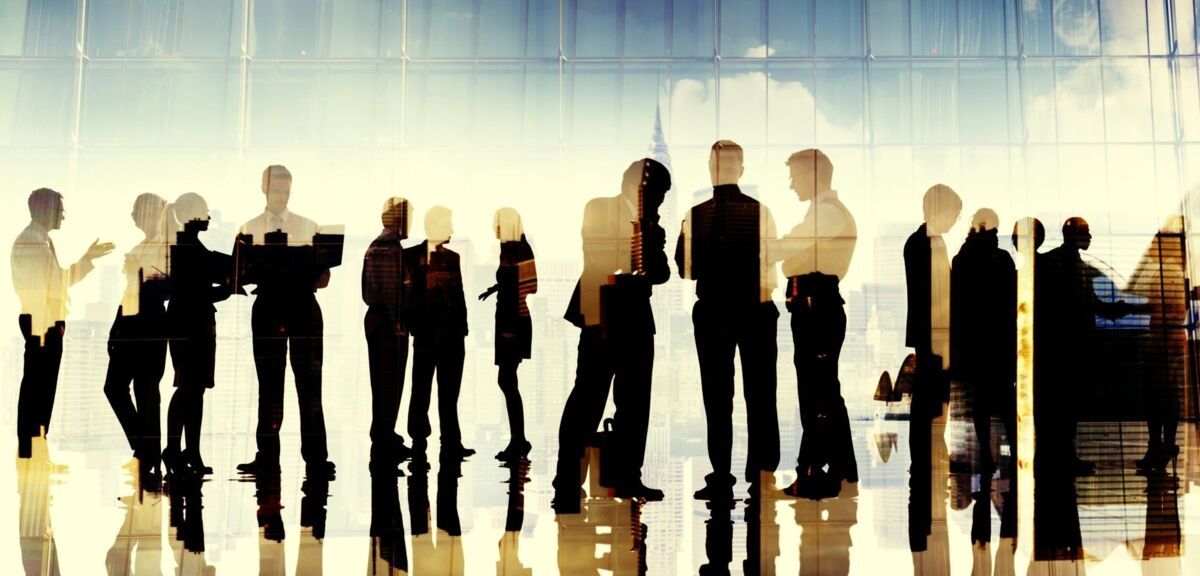 Business people standing in a modern building. The image is mirrored and multi-layered. 