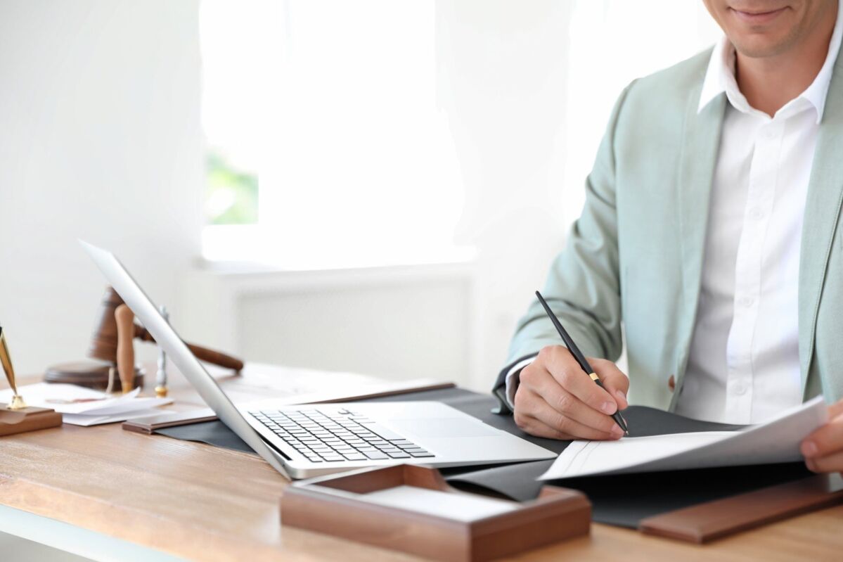 accreditation-dqs-man signing a form