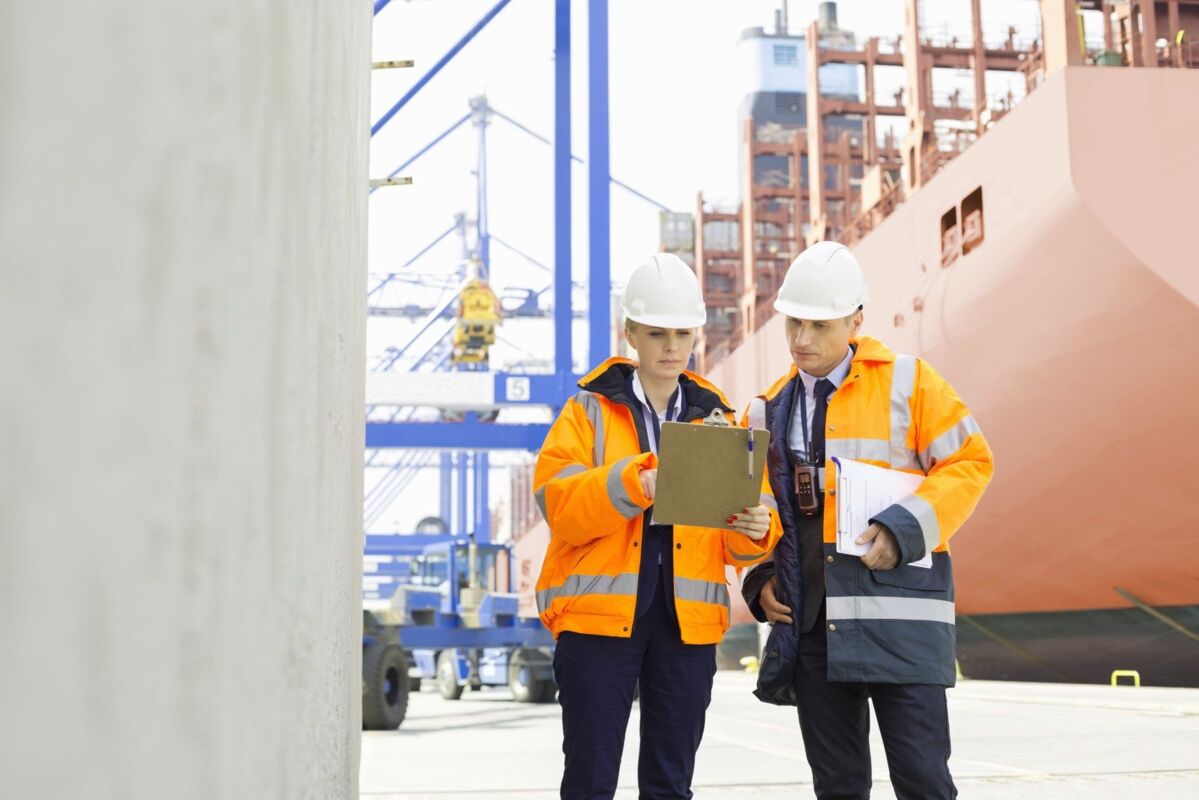 dqs-two workers accomplish a task on ship harbor