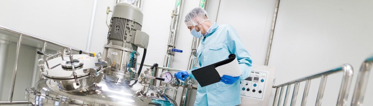 wide-screen picture, scientist in blue lab suit and gas mask working with control panel, look at ste