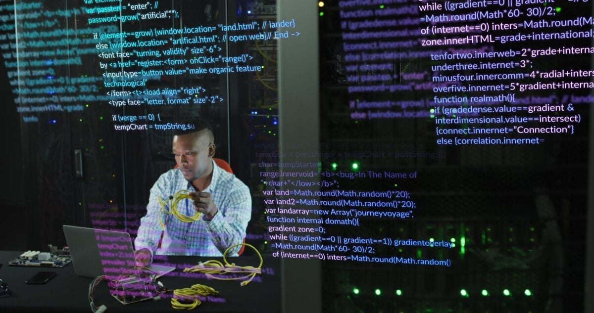 Image of data processing over african american male engineer with laptop working at server room. Com