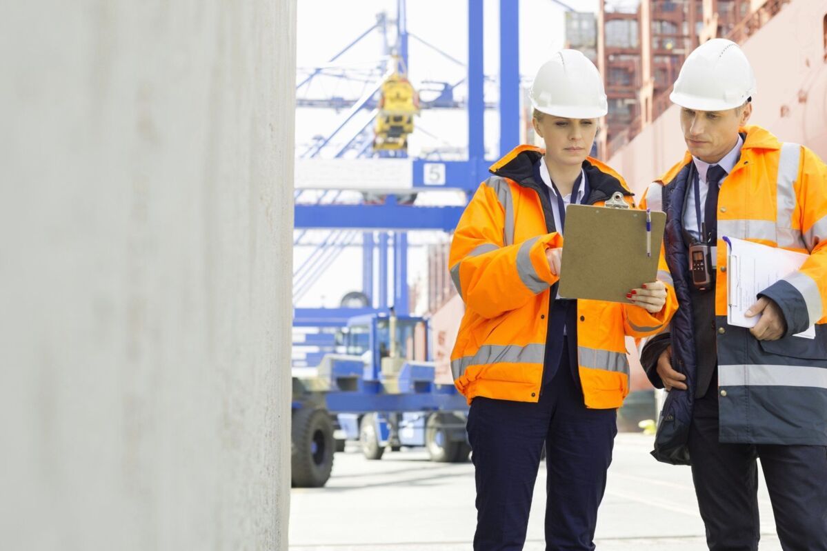 iso-45001-introducing-dqs-two workers complete tasks at ship port