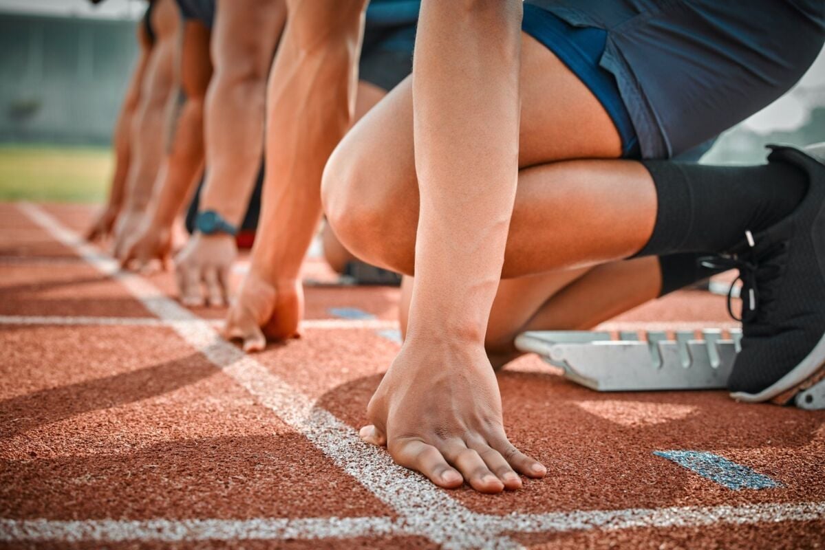 Race, start and hands of men on track at arena for speed challenge, marathon event and sports. Ready