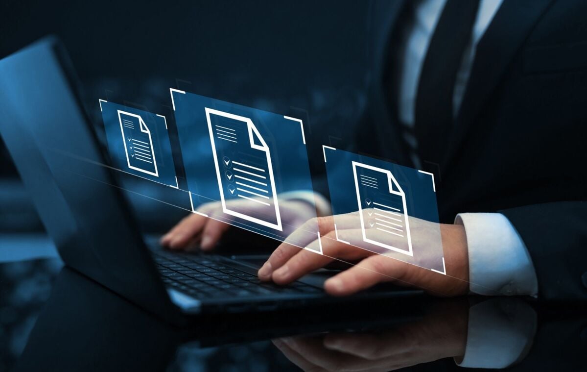 certification-rule-dqs-a business person in a suit is typing on a laptop computer