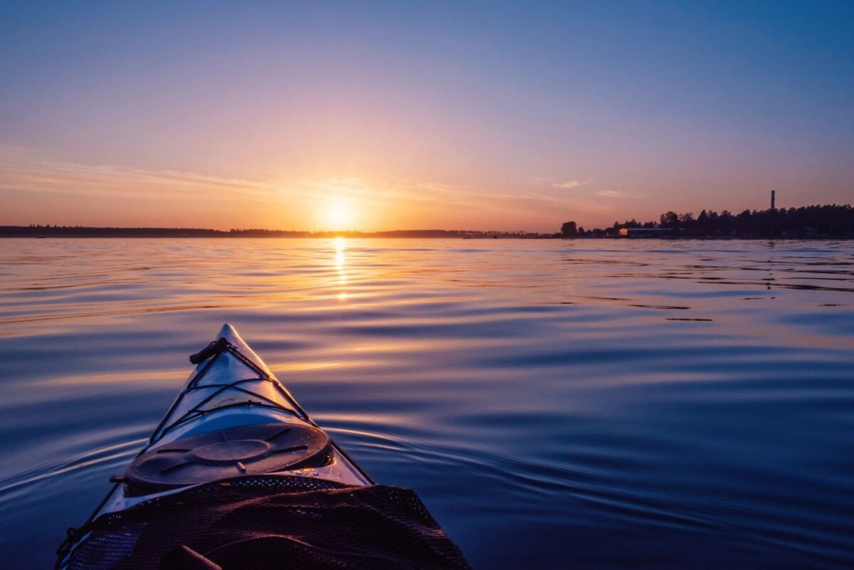 Sunset sky on the lake. View from the kayak.The image was downloaded from Depositphotos under a lice