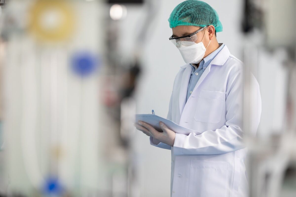 dqs-worker in medical clothing controls production in factory