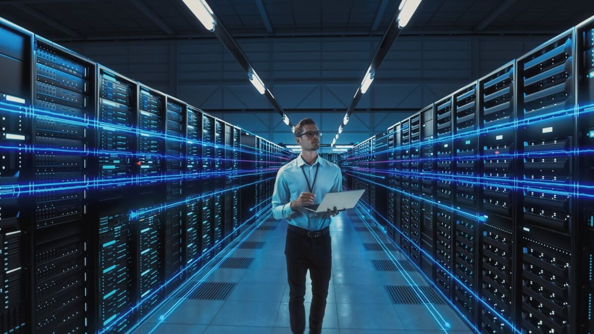 webinar-information security-dqs-it expert checks data in server room with laptop
