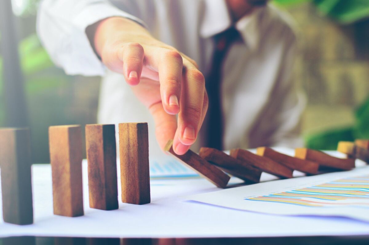 Business control concept by stopping domino effect