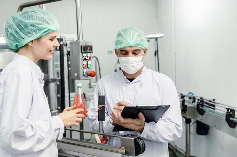 Food and drink factory ISO audit quality control team working, hygiene check and process standard in