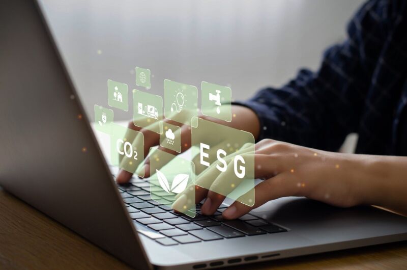 Young man sitting using a computer to analyze ESG, environment, conservation, society, governance, c