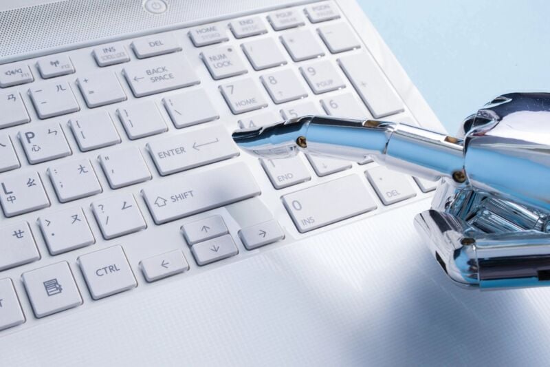 robot finger types on keyboard, artificial intelligence