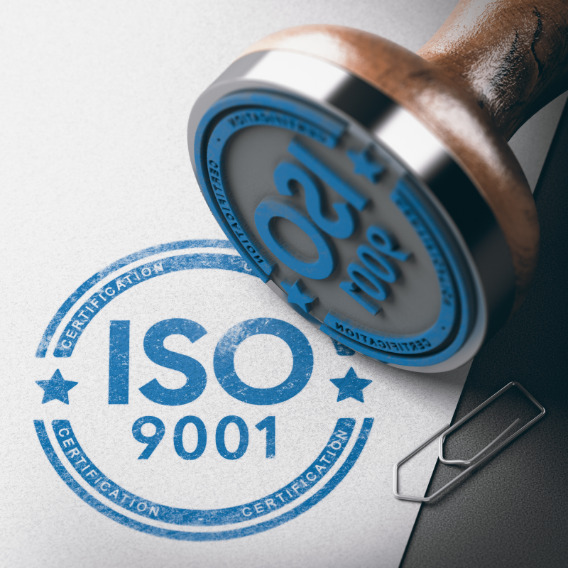 3D illustration of a rubber stamp with the text ISO 9001 certification over paper background.; Shutt