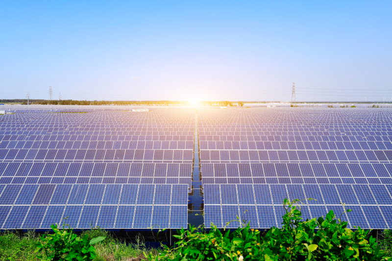 energy-efficiency-dqs-solar photovoltaic panels on the meadow under a blue sky